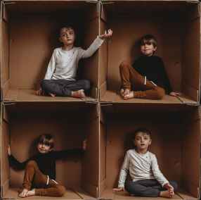 photo of boys sitting on box
